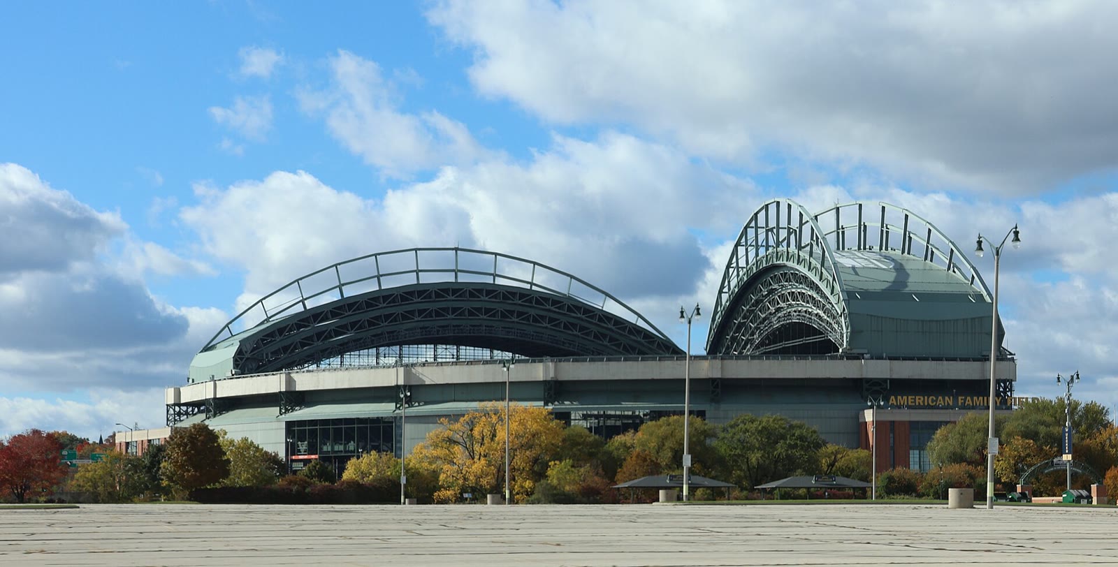 Estadio American Family Field de Milwaukee, con su techo curvo, bajo un cielo con nubes